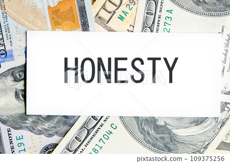 HONESTY text, a word written on a white business card against a background of money 109375256