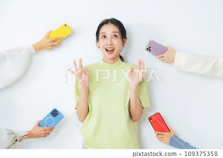 A woman is surprised when a smartphone is handed to her A woman is surprised when a smartphone is handed to her 109375358