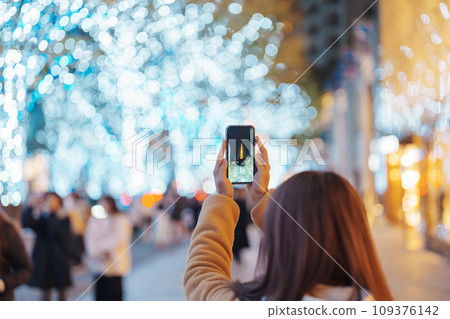 Traveler visiting Roppongi Hills Christmas Illumination and taking photo Tokyo tower, happy tourist woman stands on a christmas market in Tokyo, Japan. Travel, holiday and celebrations concept Traveler visiting Roppongi Hills Christmas Illumination and taking photo Tokyo tower, happy tourist woman stands on a christmas market in Tokyo, Japan. Travel, holiday and celebrations concept 109376142