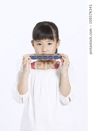 girl playing harmonica 109376341