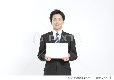 A businessman with a message board A businessman with a message board 109376391