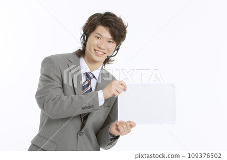 A businessman with a message board 109376502