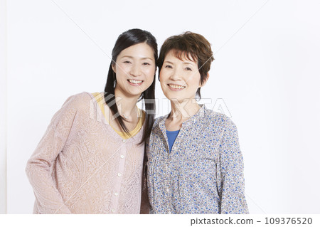 Portrait of smiling grandmother and daughter 109376520