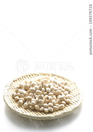 A photo of ginkgo seeds in a basket against a white background 109376728