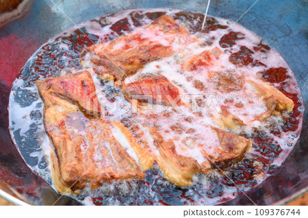 Frying crispy pork requires high heat and a lot of oil. Frying crispy pork requires high heat and a lot of oil. 109376744