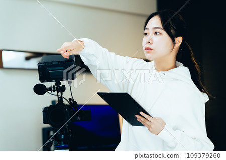 young woman filming a video young woman filming a video 109379260