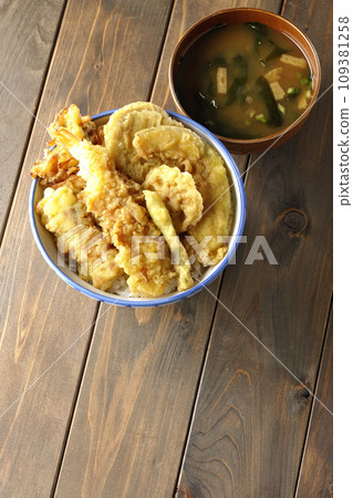 A tempura bowl with lots of ingredients such as shrimp, chikuwa, green beans, pumpkin, sweet potato, and lotus root, and miso soup. A tempura bowl with lots of ingredients such as shrimp, chikuwa, green beans, pumpkin, sweet potato, and lotus root, and miso soup. 109381258