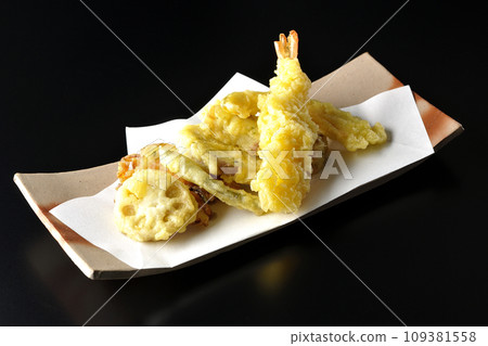 Assorted tempura of shrimp, chikuwa, green beans, pumpkin, sweet potato, and lotus root photographed against a black background Assorted tempura of shrimp, chikuwa, green beans, pumpkin, sweet potato, and lotus root photographed against a black background 109381558