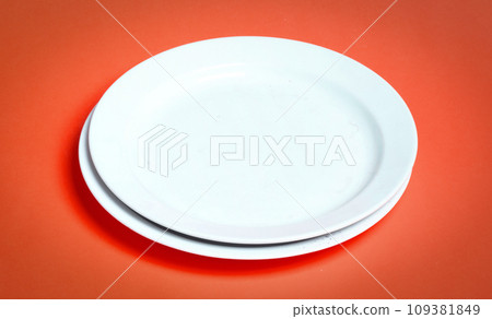 Two white plates on a solid background Two white plates on a solid background 109381849