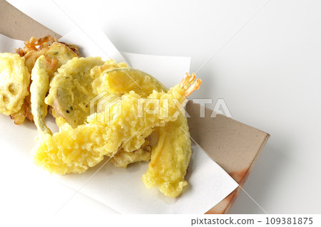 An overhead shot of an assortment of shrimp, chikuwa, green beans, pumpkin, sweet potato, and lotus root tempura against a white background An overhead shot of an assortment of shrimp, chikuwa, green beans, pumpkin, sweet potato, and lotus root tempura against a white background 109381875