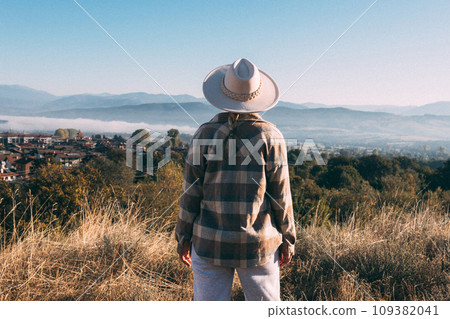 Closeup photo of a young woman enjoying and contemplating the mountains. Closeup photo of a young woman enjoying and contemplating the mountains. 109382041