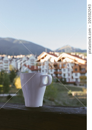 a cup of tea against the backdrop of the hotel and beautiful mountains in Bansko, Bulgaria a cup of tea against the backdrop of the hotel and beautiful mountains in Bansko, Bulgaria 109382043
