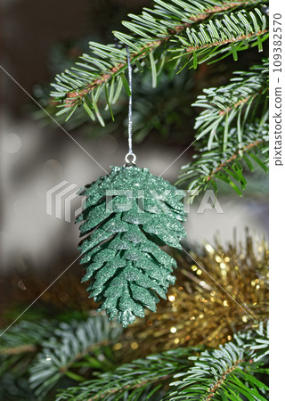 Green cone hanging on christmas tree Green cone hanging on christmas tree 109382570