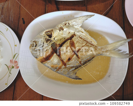 Thai sea food , Deep fried promfet with fish sauce . Thai sea food , Deep fried promfet with fish sauce . 109382749