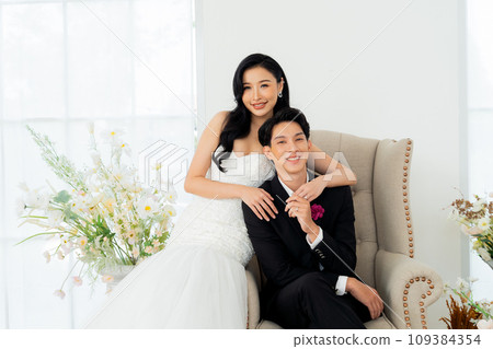 Groom and bride together, exuding elegance and joy in a bright wedding portrait setting - Pre wedding posed for photography Groom and bride together, exuding elegance and joy in a bright wedding portrait setting - Pre wedding posed for photography 109384354