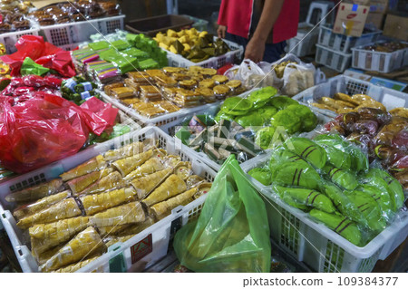 Many varieties of traditional snacks sold in the Marketplace in dawn time in Surabaya, East Java, Indonesia. 109384377