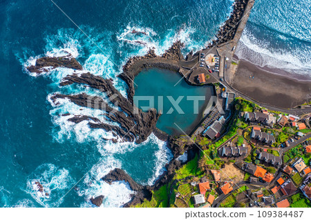 Aerial view of Madeira island. Land meets ocean in Seixal, Madeira, Portugal Aerial view of Madeira island. Land meets ocean in Seixal, Madeira, Portugal 109384487