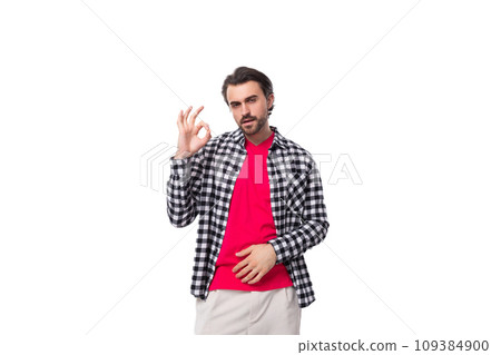 handsome pleasant young european man with black hair and beard in a shirt on a white background with 109384900