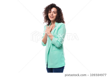 portrait of a young brunette curly businesswoman dressed in a blue jacket on a white background with 109384977
