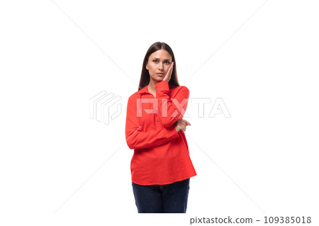 upset young business woman with black hair dressed in a red blouse on a white background with copy 109385018