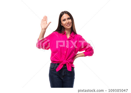 young slender brunette leader woman in a bright pink shirt shows a gesture of welcome 109385047