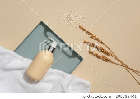 Beige background featured a tray with unbranded pump bottle and white towel displayed on. Rice bran powder not only decongests pores, but also can brighten Beige background featured a tray with unbranded pump bottle and white towel displayed on. Rice bran powder not only decongests pores, but also can brighten 109385401