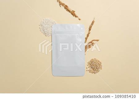 Facial mask package decorated with wheat seeds, rice and wheat ears. Rice bran has been used for centuries in Japan as a key ingredient in cleansers 109385410