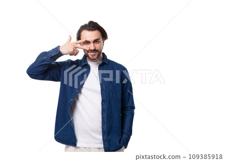 young well-groomed brunette guy in a casual blue shirt on a white coin with copy space 109385918