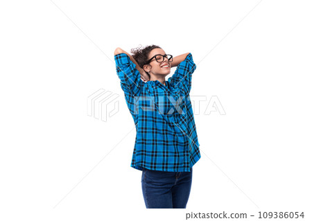 young smiling energetic curly european woman dressed casually in a blue plaid shirt on a white young smiling energetic curly european woman dressed casually in a blue plaid shirt on a white 109386054