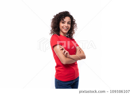 corporate clothing concept. young smiling curly brunette woman in red t-shirt on white background corporate clothing concept. young smiling curly brunette woman in red t-shirt on white background 109386107