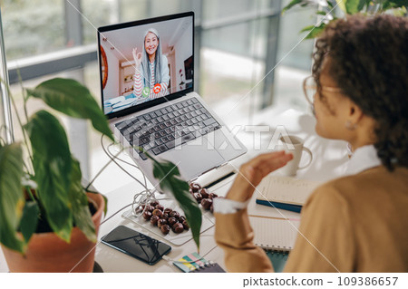 Female freelancer have video conference with client while sitting in cozy coworking 109386657