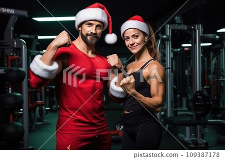 Santa Claus fitness trainers. A muscular man and woman in a gym 109387178