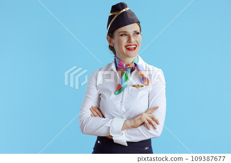 happy flight attendant woman on blue looking at copy space 109387677