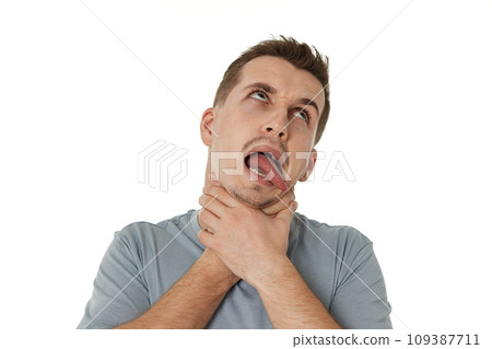 guy grimaces and grabs his throat with his hands on white background. guy grimaces and grabs his throat with his hands on white background. 109387711
