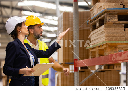 Female manager talking with foreman. Warehouse, production worker preparing products for shipment. Woman quality controller checking quality of products, talking with technician. Female manager talking with foreman. Warehouse, production worker preparing products for shipment. Woman quality controller checking quality of products, talking with technician. 109387825
