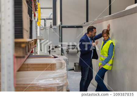 Female worker in manufactury feeling vulnerable and intimidated by superior manager, forced touching at workplace. Sexual harassment at work. 109387835