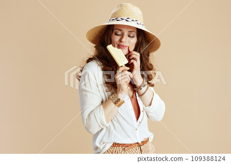 happy 40 years old woman in blouse and shorts against beige 109388124