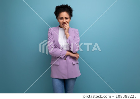 young charming successful hispanic business woman with curly hair dressed in a purple jacket on a 109388223