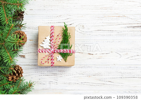 Christmas gift box wrapped in recycled paper, with ribbon bow, with ribbon on rustic background. Holiday concept 109390358