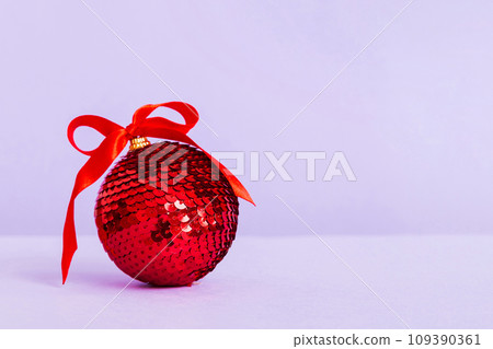 Christmas ball on colored background. decoration bauble with ribbon bow with copy space Christmas ball on colored background. decoration bauble with ribbon bow with copy space 109390361