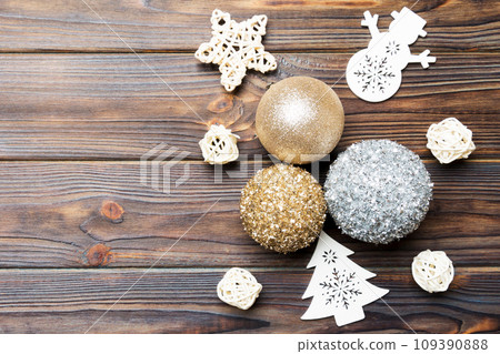 Top view of festive winter composition on wooden background with empty space for your design. Christmas baubles and decorations. New Year concept Top view of festive winter composition on wooden background with empty space for your design. Christmas baubles and decorations. New Year concept 109390888