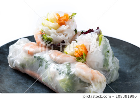 Vietnamese spring rolls with vegetables, rice noodles and prawns isolated on white background Vietnamese spring rolls with vegetables, rice noodles and prawns isolated on white background 109391990