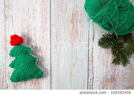 Knitted Christmas tree. Close-up. Handmade Christmas gifts. Copy space Knitted Christmas tree. Close-up. Handmade Christmas gifts. Copy space 109392408