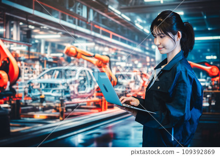 Young woman using a computer on the factory production line 109392869