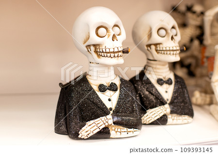Skeleton in a tuxedo and a cigar in a shop Halloween Costume Store 109393145