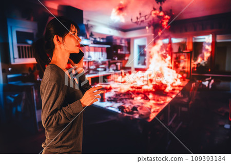 A young woman reports a fire to the fire department 109393184