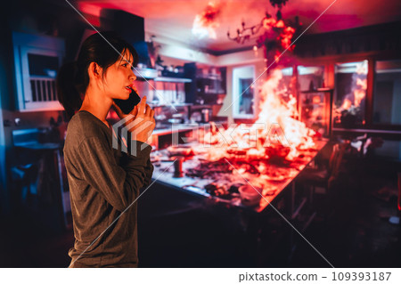 A young woman reports a fire to the fire department 109393187