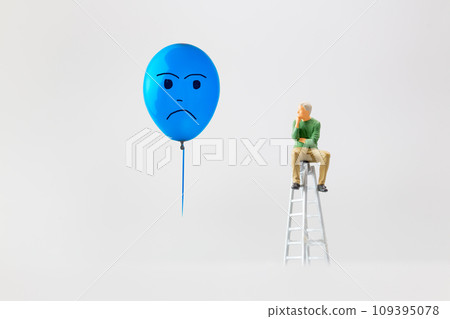 Miniature people, A despondent businessman with a blue balloon is sitting on a staircase. , Blue monday concept. 109395078