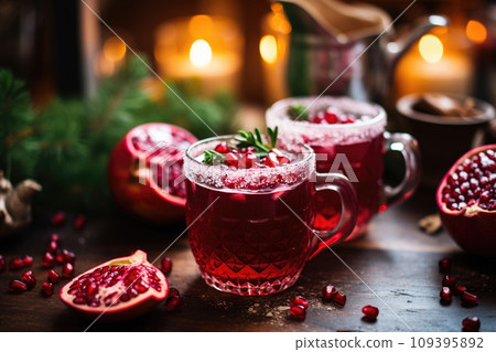 A close-up of hot Christmas punch with a pomegranate slice, in a cozy cafe A close-up of hot Christmas punch with a pomegranate slice, in a cozy cafe 109395892