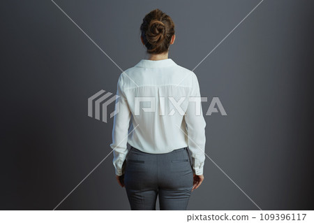 Seen from behind woman worker isolated on gray 109396117